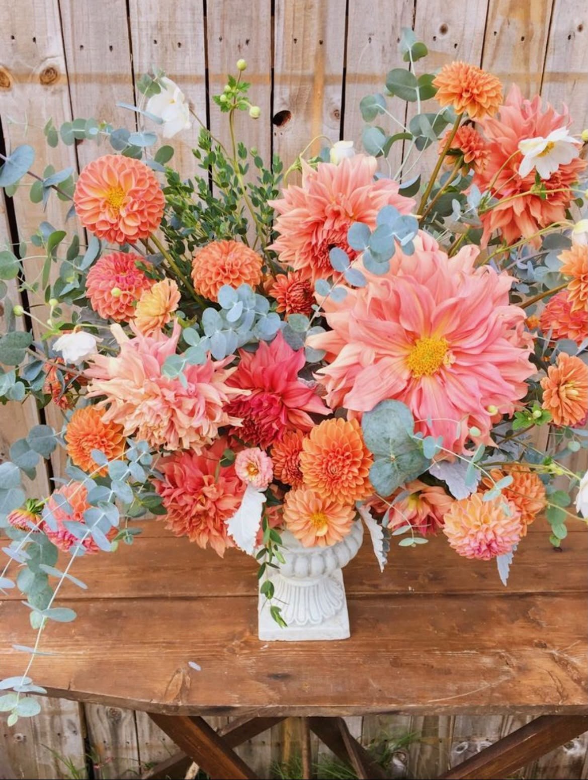 Grande composition de dahlias corail et pêche avec eucalyptus, création Maluna