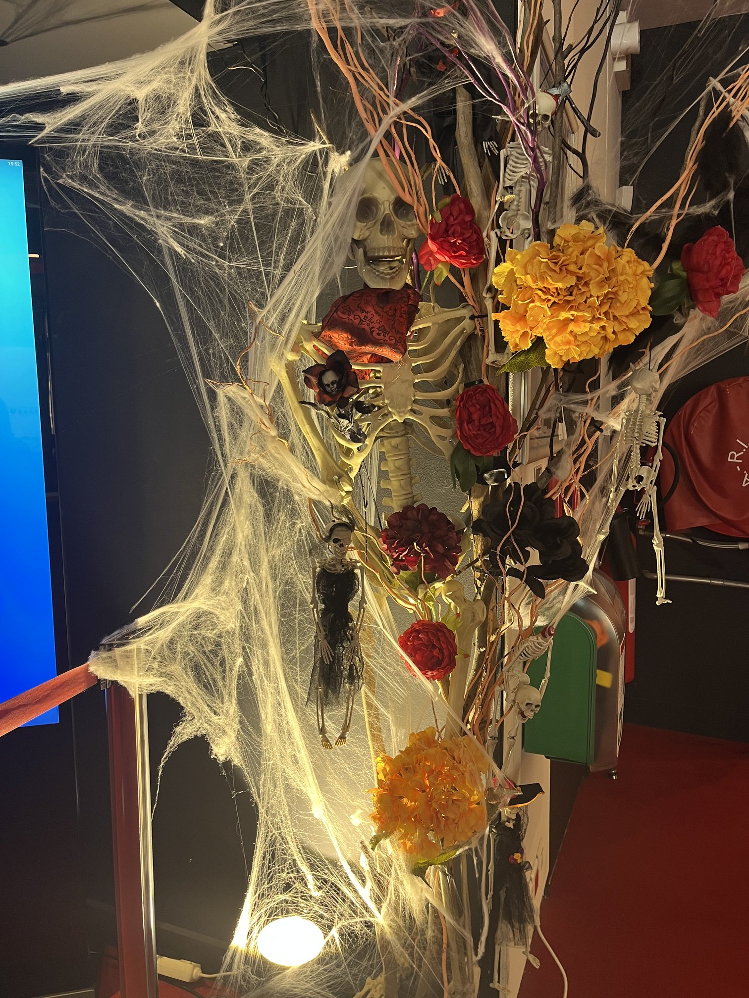 Décoration d'Halloween avec squelette, toiles d'araignée et fleurs artificielles rouges et jaunes au Casino Partouche Bandol